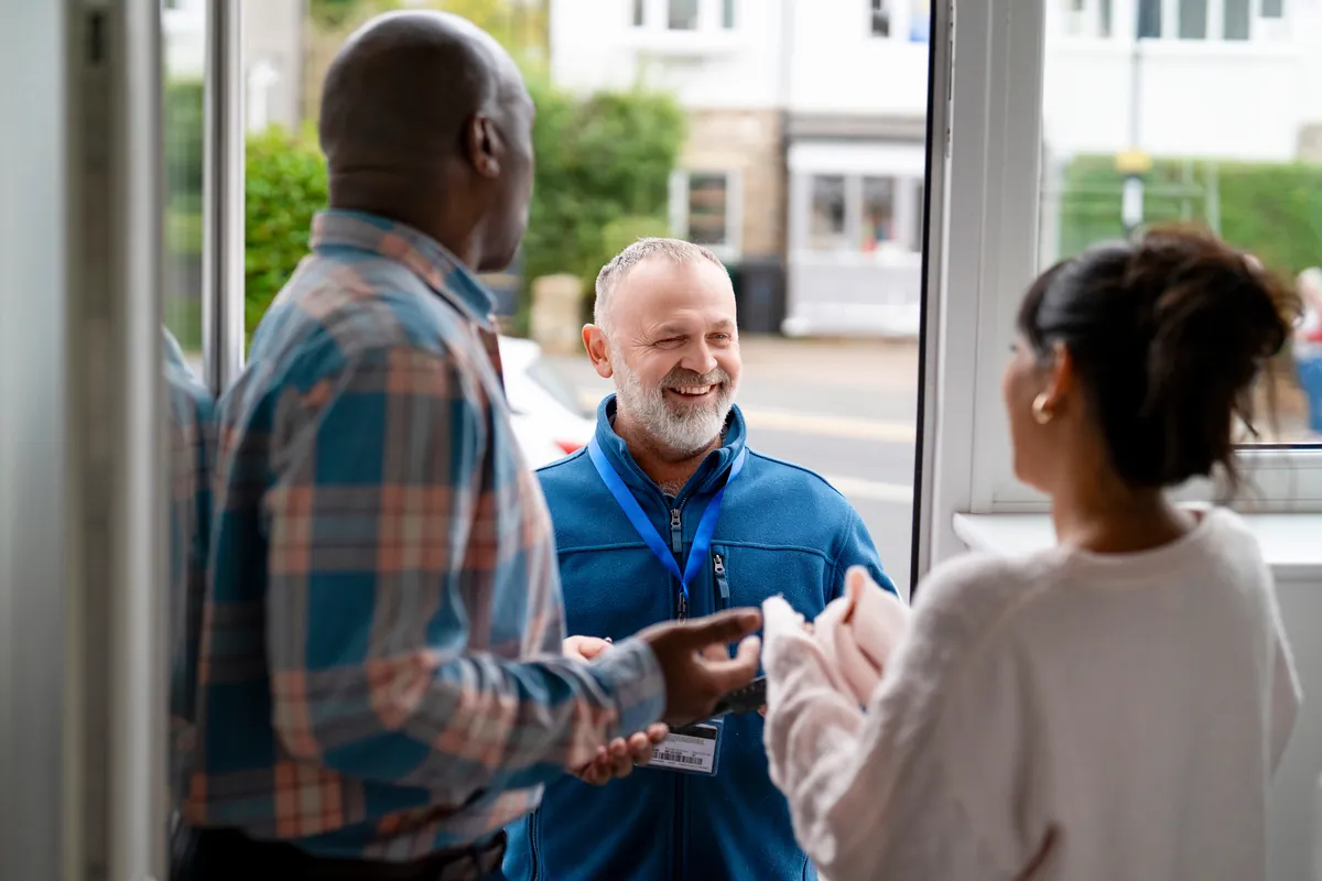 Technician and homeowner shaking hands after completing a service visit.
